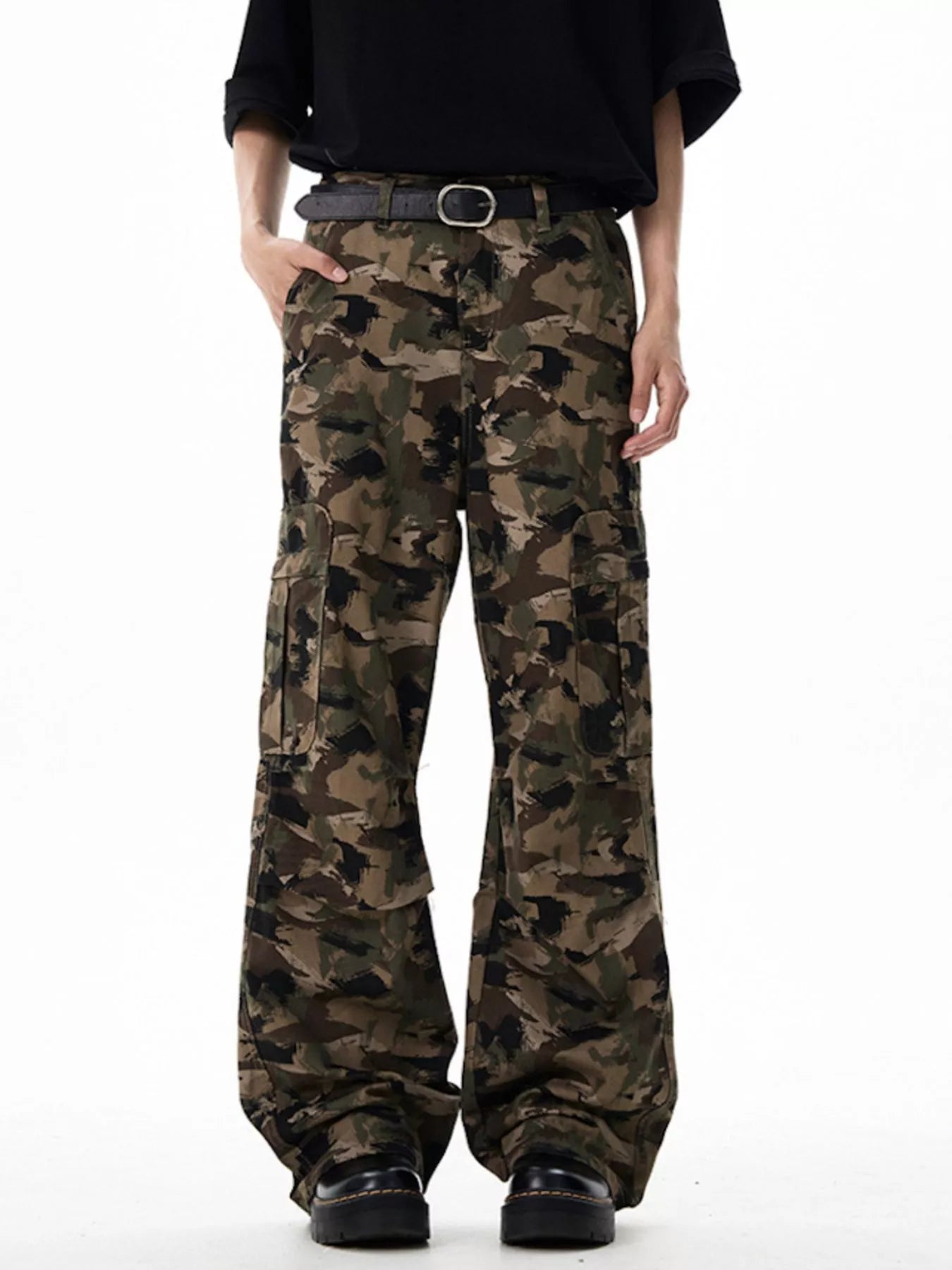 Camouflage pants worn by a person on a white background