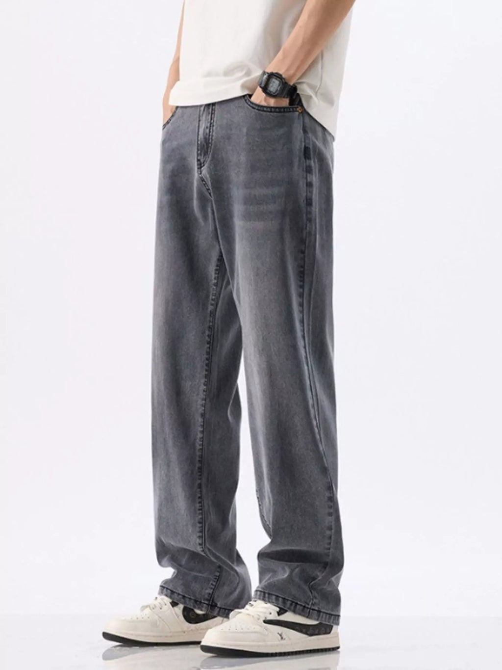 Person wearing gray jeans and a white shirt on a white background