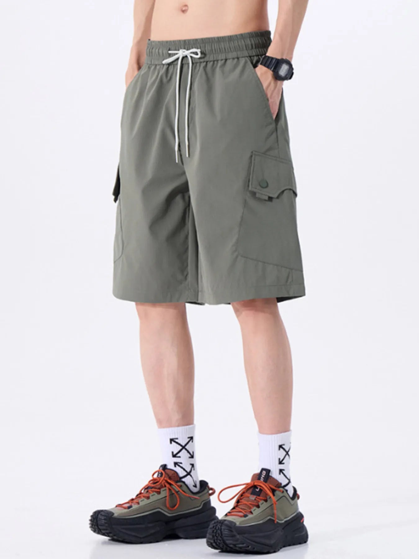 Person wearing grey shorts on a white background