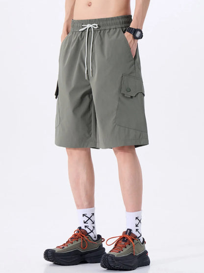 Person wearing grey shorts on a white background